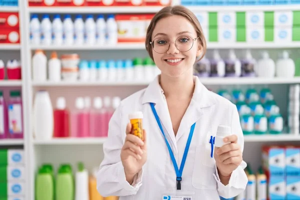 Young Blonde Woman Pharmacist Smiling Confident Holding Two Pills Bottles — ストック写真