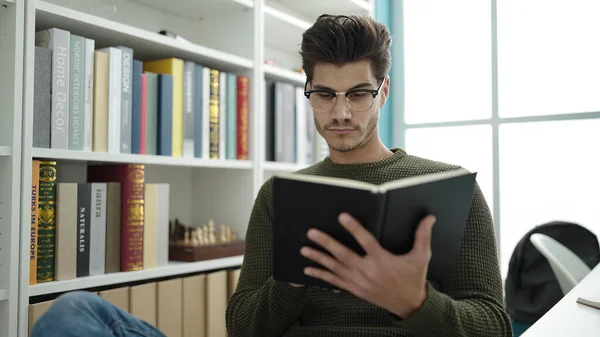 Young Hispanic Man Student Reading Book Studying Library University — Stockfoto