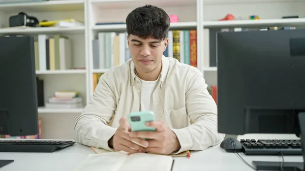 Young Hispanic Man Student Using Smartphone Sitting Table Library University — стоковое фото