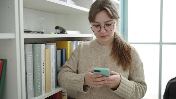 Young Blonde Woman Student Using Smartphone Library University — Zdjęcie stockowe