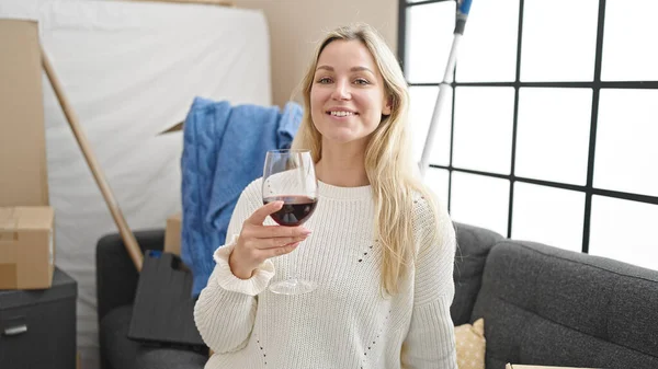 Young Blonde Woman Drinking Glass Wine Sitting Sofa New Home — Stock Photo, Image