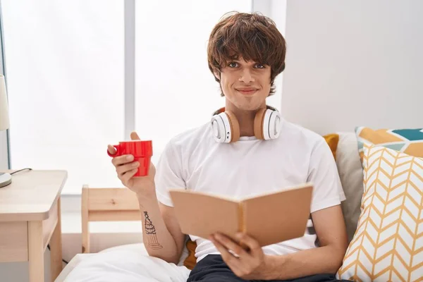 Young Blond Man Reading Book Drinking Coffee Bedroom — Stock Photo, Image