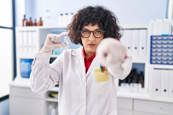 Hispanic Doctor Woman Curly Hair Holding Vaccine Pointing Finger Camera — Stock Photo, Image