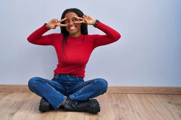 Young African American Braids Sitting Floor Home Doing Peace Symbol — Stockfoto
