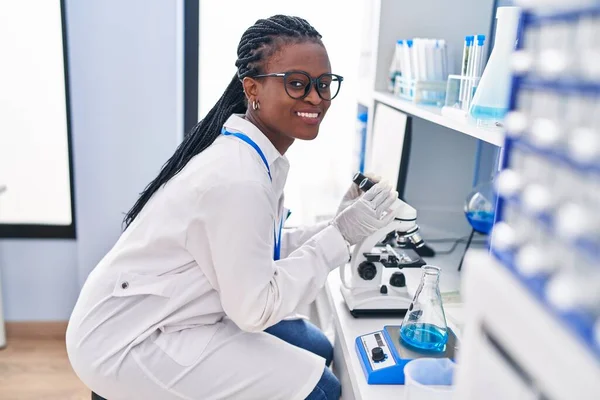 African American Woman Scientist Smiling Confident Using Microscope Laboratory — ストック写真