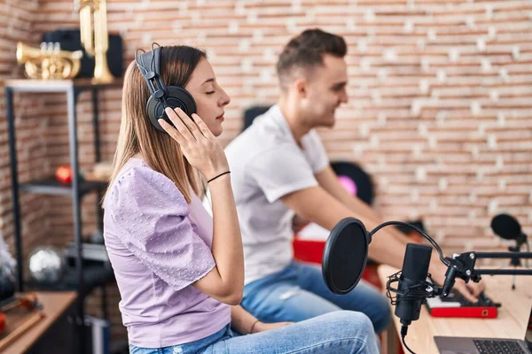 stock image Man and woman musicians listening to music composing song at music studio