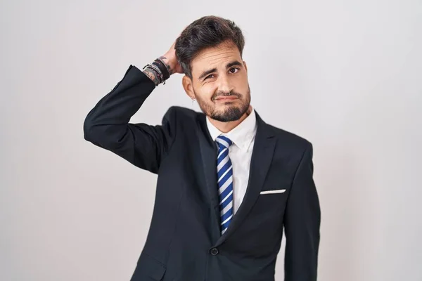 ビジネススーツを着てネクタイをしている若いヒスパニック系の男は混乱し 質問を疑問に思っています 疑いもなく頭に手を置いて考える 包括的な概念は — ストック写真