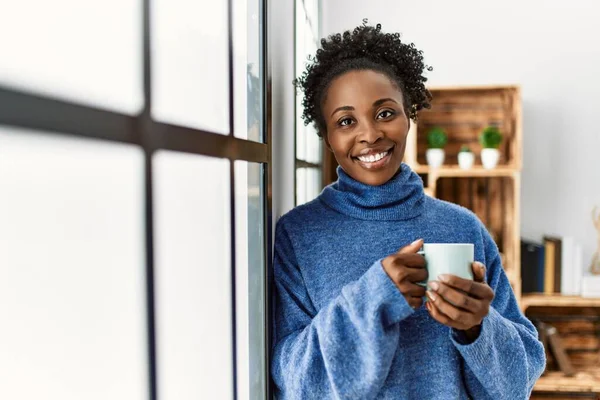 African American Woman Drinking Coffee Leaning Window Home — Stockfoto