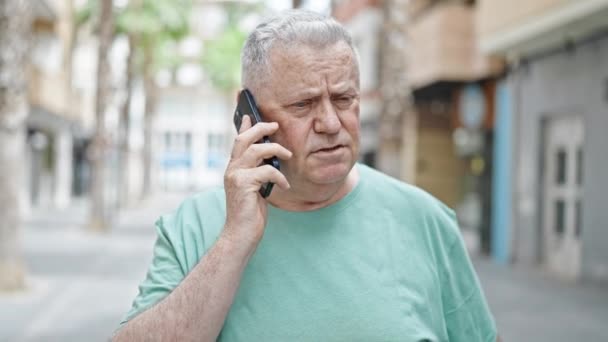 Middle Age Grey Haired Man Talking Smartphone Serious Expression Street — Vídeos de Stock