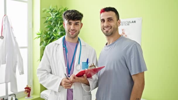 Two Men Doctor Patient Smiling Confident Standing Clinic — Stock Video