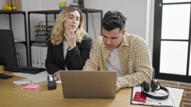 Man and woman business workers using laptop working at office