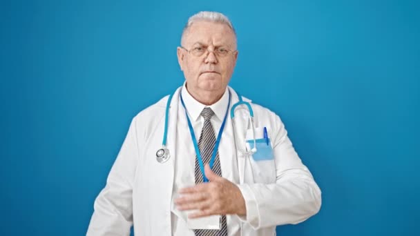 中世の白髪の男医師作り誓いとともに手上の胸上の隔離された青の背景 — ストック動画