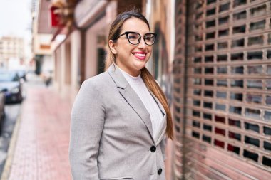 Young beautiful hispanic woman business worker smiling confident standing at street