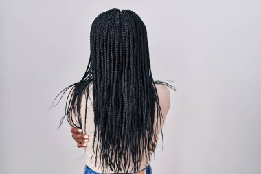 Beyaz arka planda dikilmiş örgü ören Afrikalı bir kadın mutlu ve pozitif bir şekilde kendine sarılıyor. Sevgi ve özgüven. 