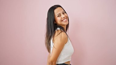 Young beautiful hispanic woman smiling confident standing over isolated pink background