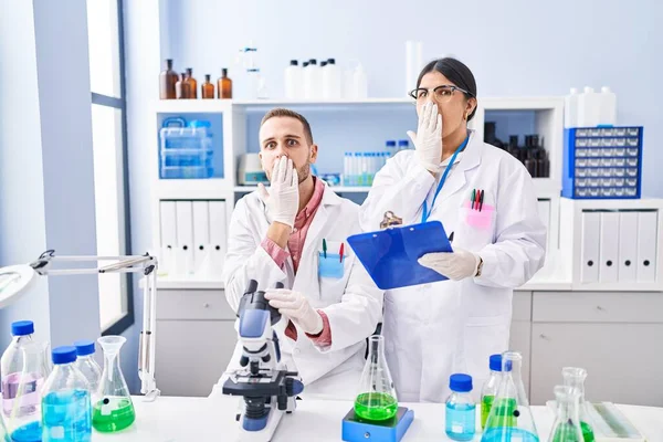 Two Young People Working Scientist Laboratory Covering Mouth Hand Shocked — Stock Photo, Image