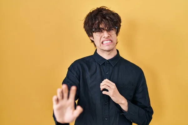 Młody Człowiek Noszący Okulary Żółtym Tle Brzydzi Się Ekspresją Niezadowolony — Zdjęcie stockowe