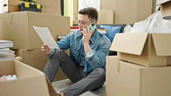 Young Hispanic Man Talking Smartphone Reading Document New Home — Foto Stock