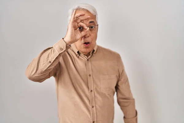 Hispanic Senior Man Wearing Glasses Doing Gesture Shocked Surprised Face — Stockfoto