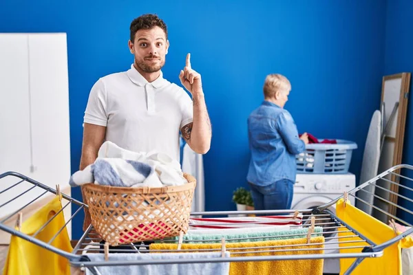 Hispanic Mother Son Hanging Clothes Clothesline Surprised Idea Question Pointing — Stock Photo, Image
