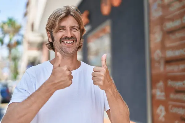 Young Blond Man Smiling Confident Doing Sign Thumbs Street — Φωτογραφία Αρχείου