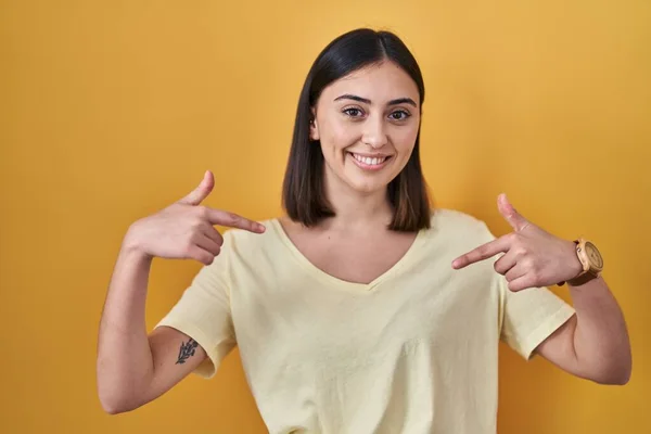 Chica Hispana Vistiendo Camiseta Casual Sobre Fondo Amarillo Mirando Confiado —  Fotos de Stock