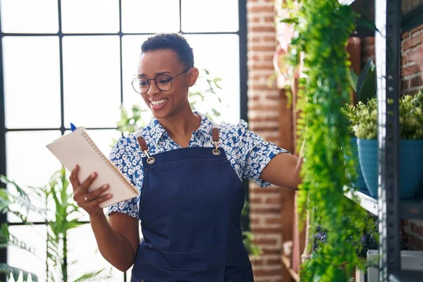 African American Woman Florist Smiling Confident Reading Notebook Florist — Stock Photo, Image