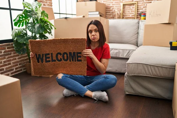 Young Hispanic Woman Holding Welcome Doormat New Home Depressed Worry — Fotografia de Stock