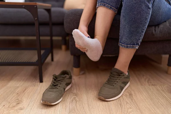 stock image Young beautiful woman suffering for feet injury at street