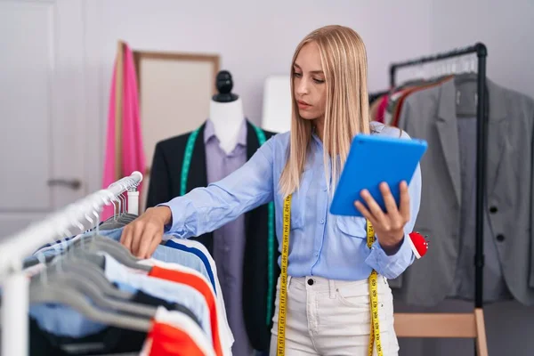 Young Blonde Woman Tailor Holding Clothes Rack Using Touchpad Tailor — Stock Fotó