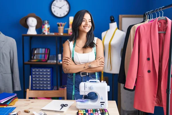 年轻的惊慌失措的女人裁缝微笑着 自信地站在缝纫工作室里 双手交叉地做着手势 — 图库照片