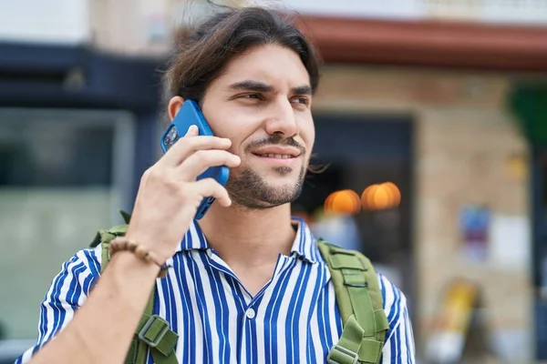 Young Hispanic Man Tourist Wearing Backpack Talking Smartphone Street —  Fotos de Stock