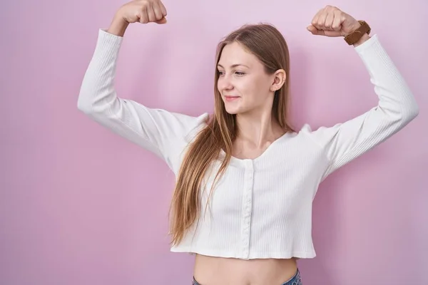 Young Caucasian Woman Standing Pink Background Showing Arms Muscles Smiling —  Fotos de Stock