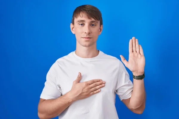 Caucasian Blond Man Standing Blue Background Swearing Hand Chest Open — Stock Photo, Image