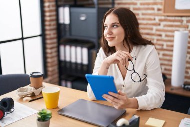 Young woman business worker using touchpad working at office