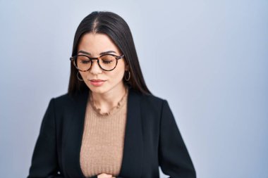 Mide bulantısı, acı verici bir hastalık yüzünden mavi arka planda duran genç esmer kadın. Ağrı kavramı. 