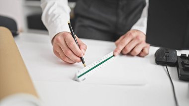 Genç İspanyol mimar ofiste ev planları çiziyor.