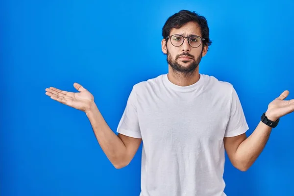 Handsome Latin Man Standing Blue Background Clueless Confused Expression Arms — Stock Photo, Image