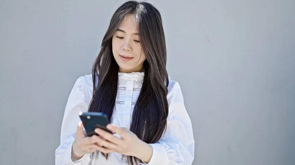 Giovane Donna Cinese Utilizzando Smartphone Con Espressione Grave Sfondo Bianco — Foto Stock