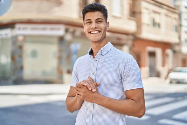 stock image Young hispanic man smiling confident standing at street