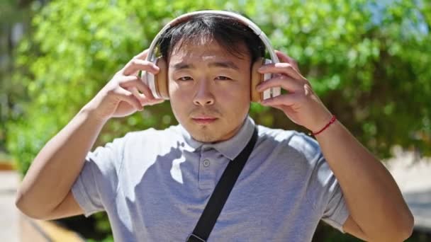 Tersenyum Percaya Diri Mengambil Headphone Taman — Stok Video