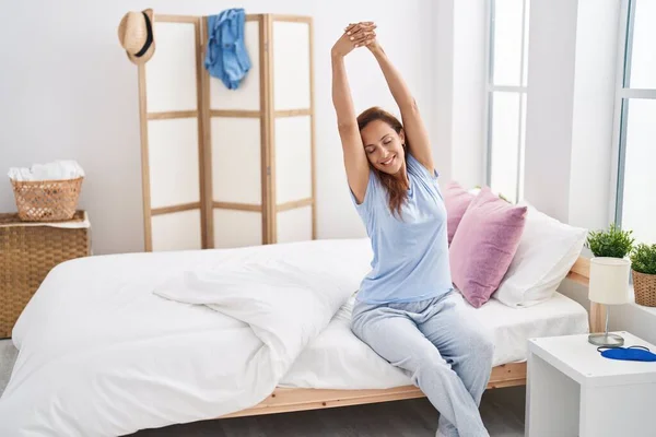Young Woman Stretching Arms Sitting Bed Bedroom — Fotografia de Stock