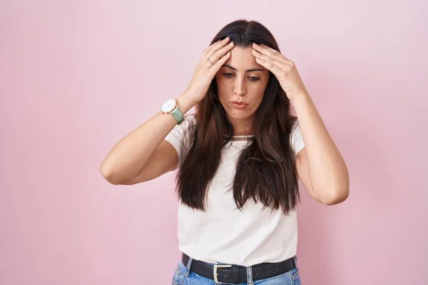 Young Brunette Woman Standing Pink Background Hand Head Headache Because — Stock Photo, Image
