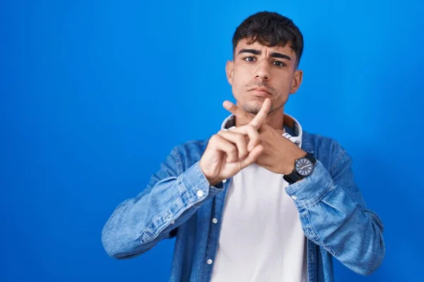 Young Hispanic Man Standing Blue Background Rejection Expression Crossing Fingers — Fotografia de Stock