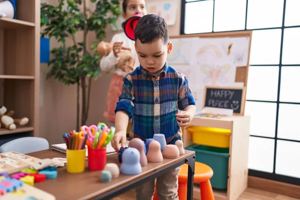 stock image Adorable boy and girl standing with relaxed expression playing at kindergarten