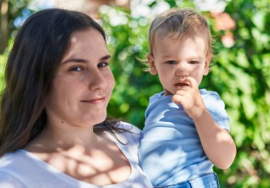 Mother and son smiling confident standing at park