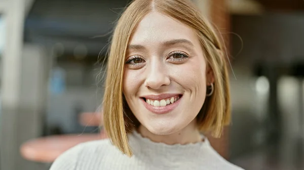 年轻的金发女子自信地站在咖啡店的阳台上微笑 — 图库照片
