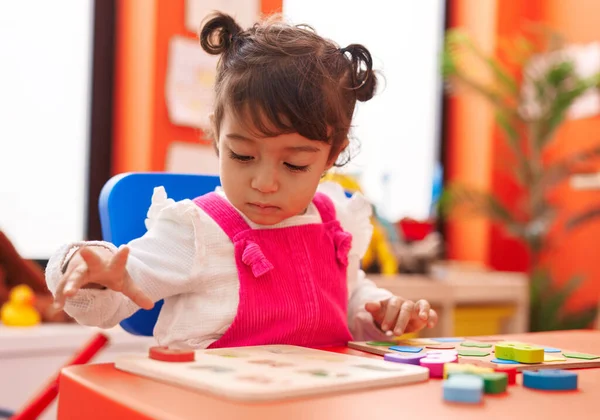 Adorable Hispanic Girl Playing Maths Puzzle Game Sitting Table Kindergarten — Fotografia de Stock