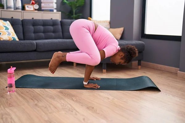 stock image African american woman doing yoga exercise at home