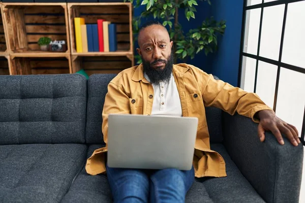 Afroamerikansk Man Använder Laptop Hemma Sitter Soffan Tänkande Attityd Och — Stockfoto